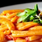 pasta with sauce and leafy greens